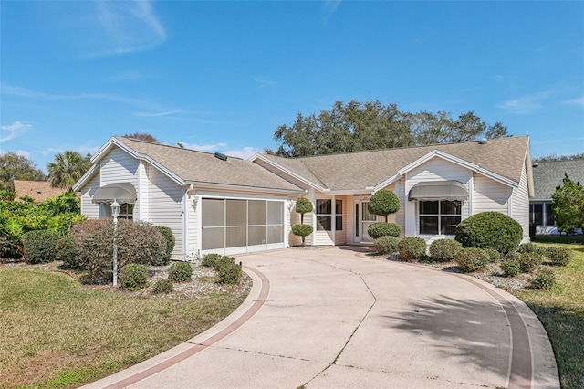 ranch-style house with a garage and a front lawn