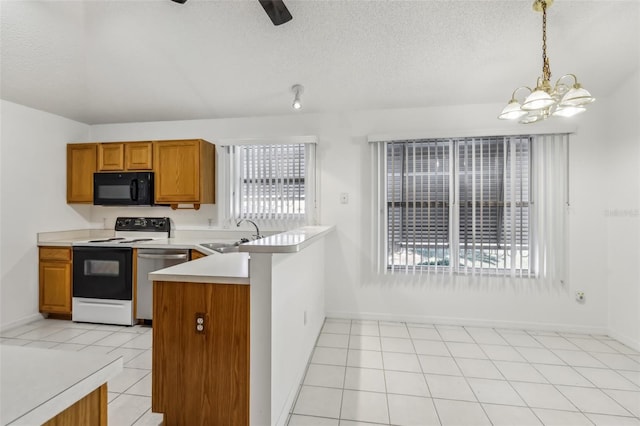 kitchen with decorative light fixtures, stainless steel dishwasher, electric range, light tile patterned floors, and kitchen peninsula