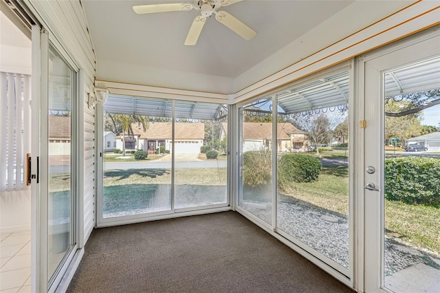 unfurnished sunroom featuring ceiling fan