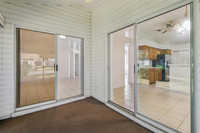 doorway with ceiling fan