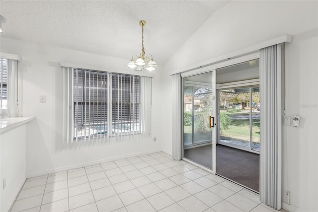 unfurnished dining area with vaulted ceiling, a chandelier, light tile patterned floors, and a textured ceiling