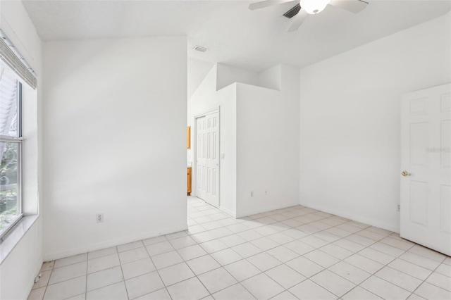 tiled empty room featuring ceiling fan