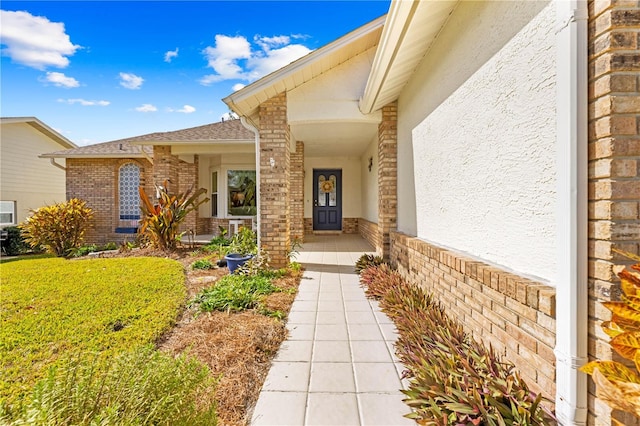 doorway to property with a yard