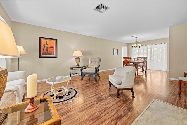 living room with wood-type flooring and a chandelier