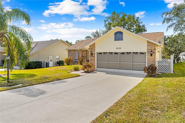 single story home featuring a garage and a front yard