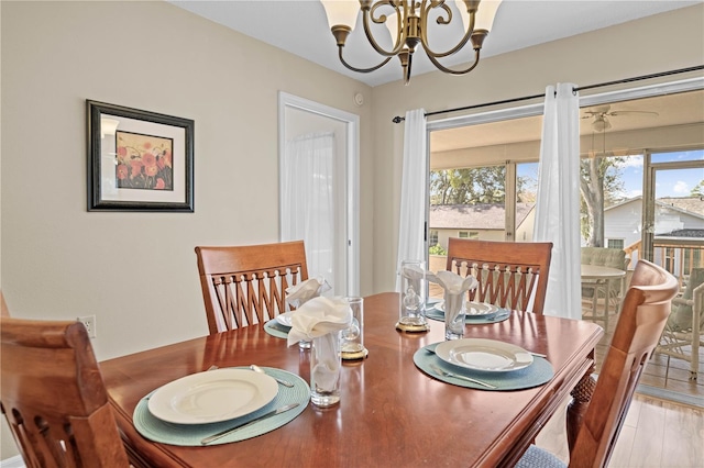 dining space featuring a notable chandelier and light hardwood / wood-style floors