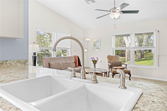 interior space featuring vaulted ceiling, sink, and ceiling fan