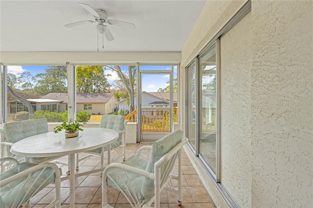 sunroom featuring ceiling fan