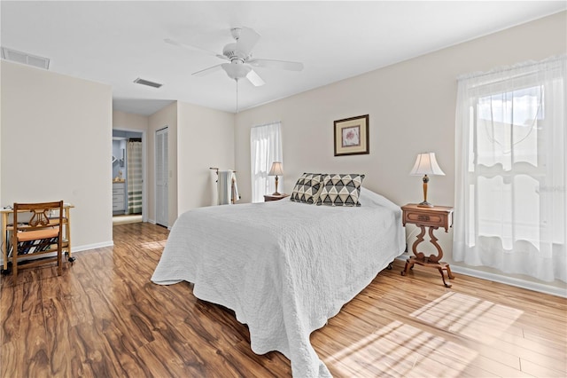 bedroom with hardwood / wood-style flooring, a closet, and ceiling fan