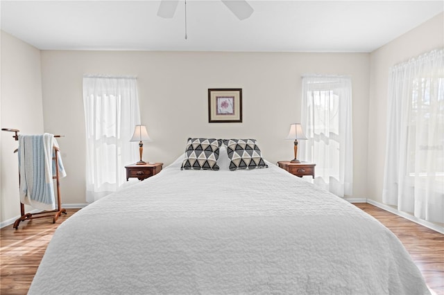 bedroom with ceiling fan and light hardwood / wood-style flooring