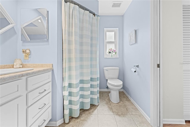 bathroom with tile patterned floors, vanity, and toilet