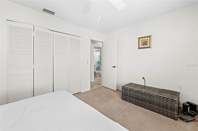 bedroom featuring ceiling fan, light carpet, and a closet