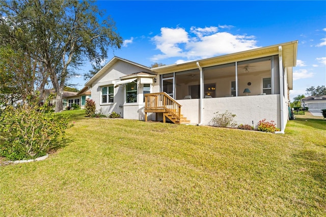 back of house with a yard, a sunroom, and ceiling fan