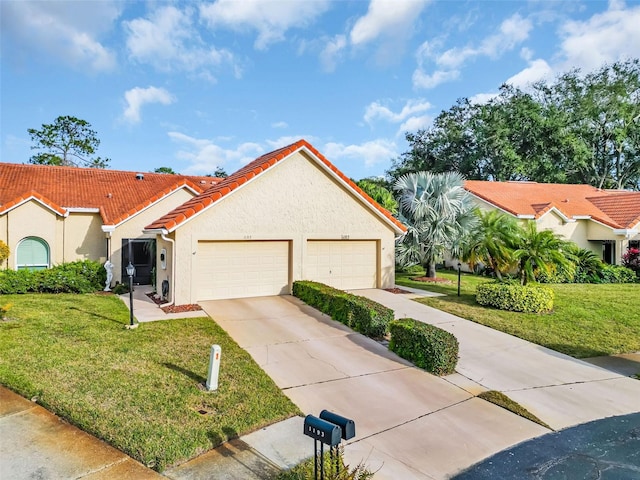 mediterranean / spanish house with a garage and a front yard