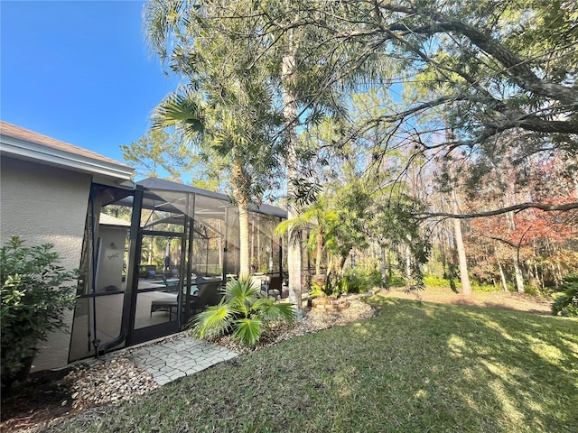 view of yard featuring glass enclosure