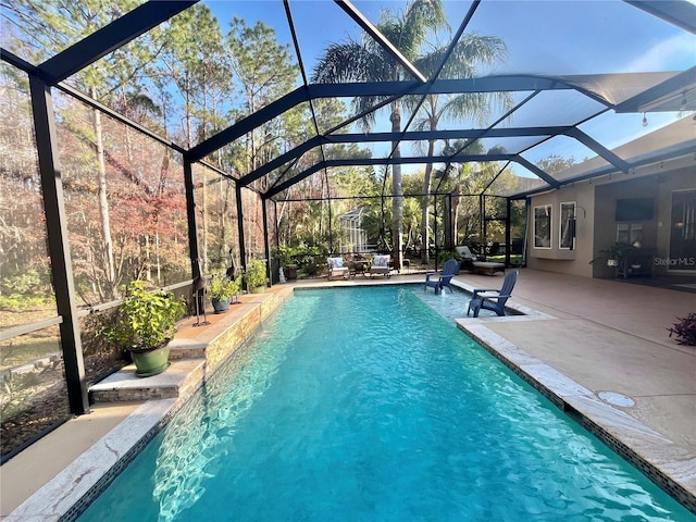 view of swimming pool featuring a lanai and a patio