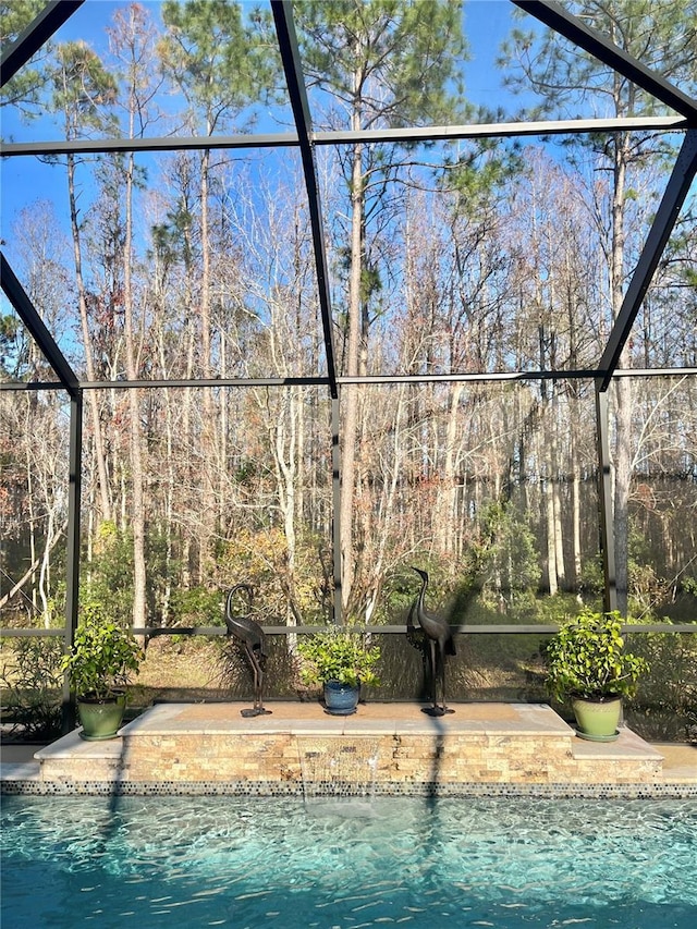 view of pool with glass enclosure