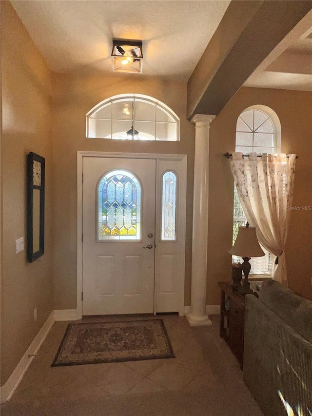 tiled entrance foyer with decorative columns