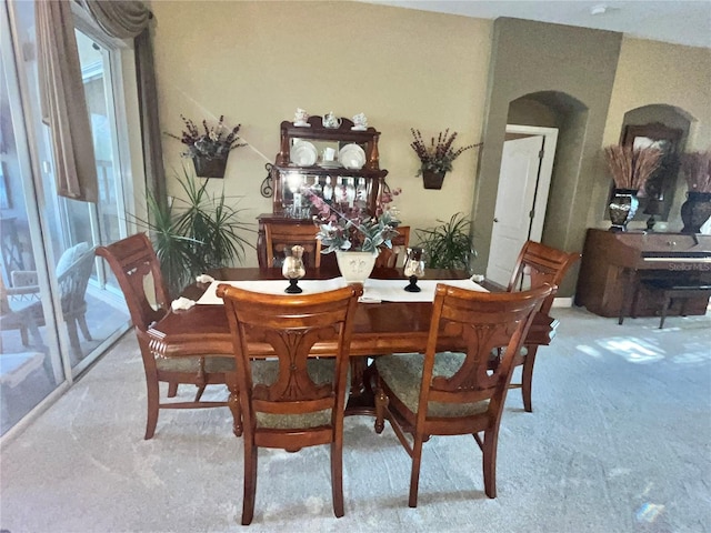 dining area with light colored carpet