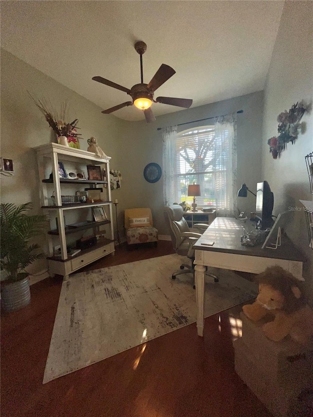 home office featuring dark hardwood / wood-style flooring and ceiling fan