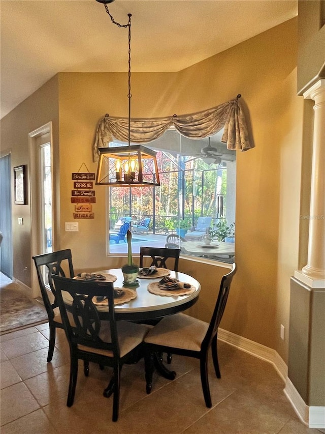 tiled dining space featuring ornate columns