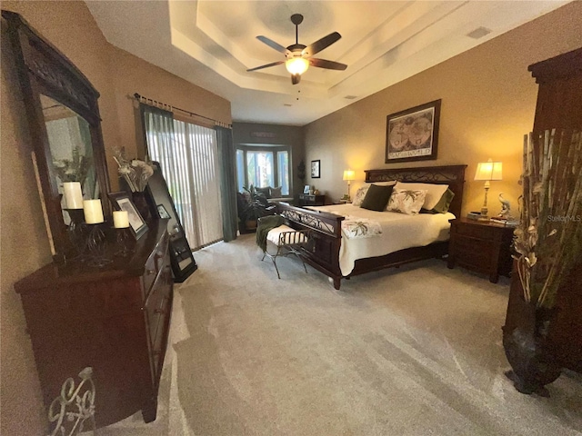 bedroom featuring a raised ceiling and ceiling fan