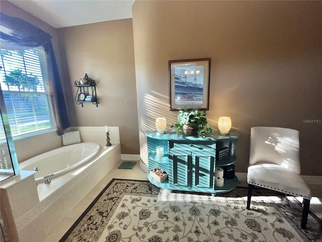 bathroom featuring tile patterned flooring, a wealth of natural light, and tiled tub