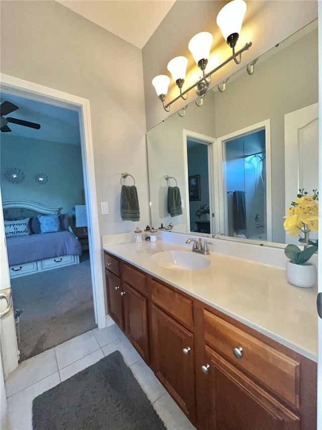 bathroom featuring vanity, ceiling fan with notable chandelier, and tile patterned floors