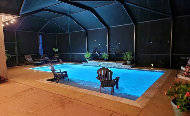 view of swimming pool with a lanai and a patio area