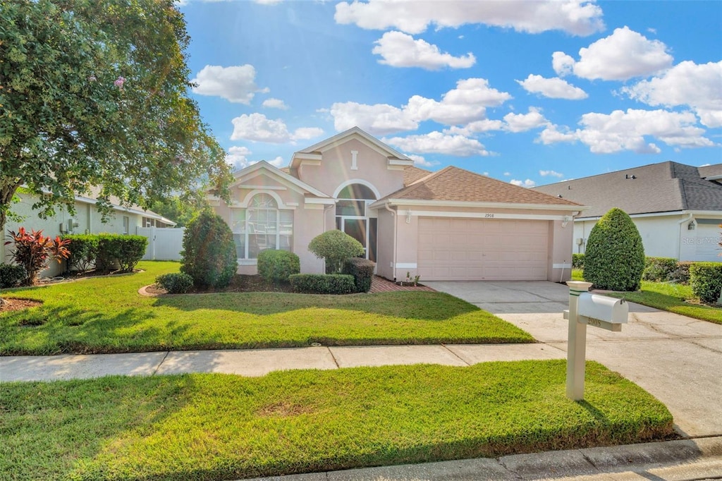 view of front of home with a garage and a front yard