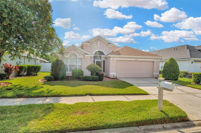 view of front of home with a garage and a front yard