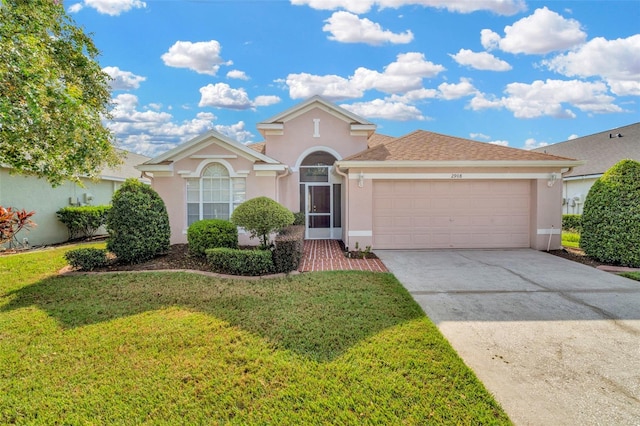 view of front of property with a garage and a front yard