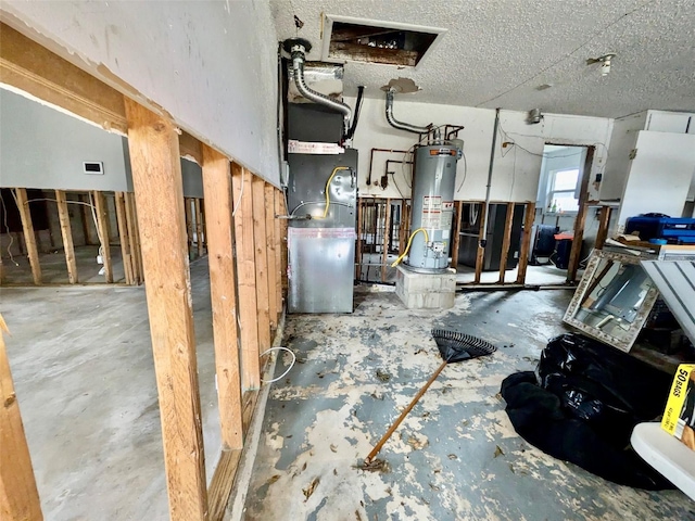 basement with water heater, a textured ceiling, and heating unit