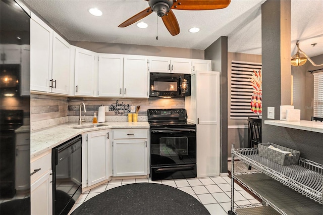 kitchen with light tile patterned floors, sink, white cabinets, and black appliances