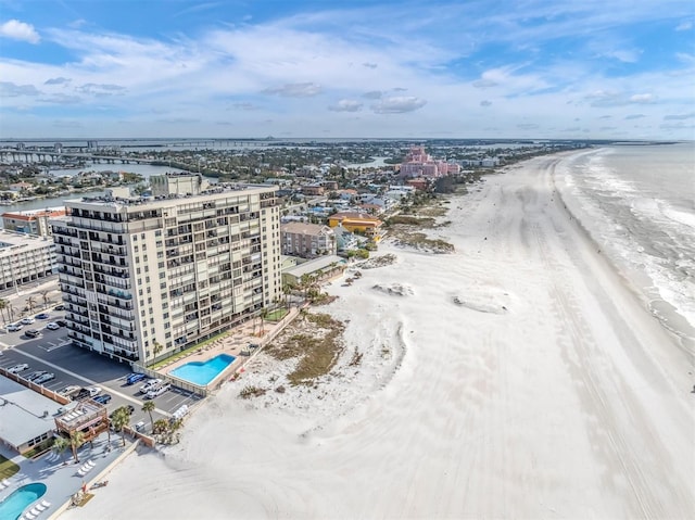 drone / aerial view featuring a water view and a beach view