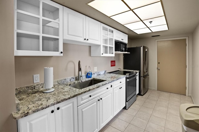 kitchen featuring white cabinetry, appliances with stainless steel finishes, sink, and light tile patterned floors