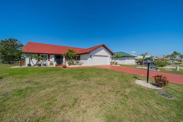 ranch-style house featuring a garage and a front yard