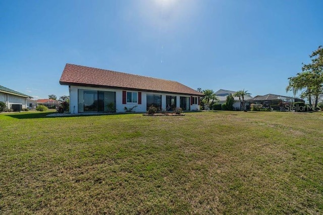 back of property featuring a lawn