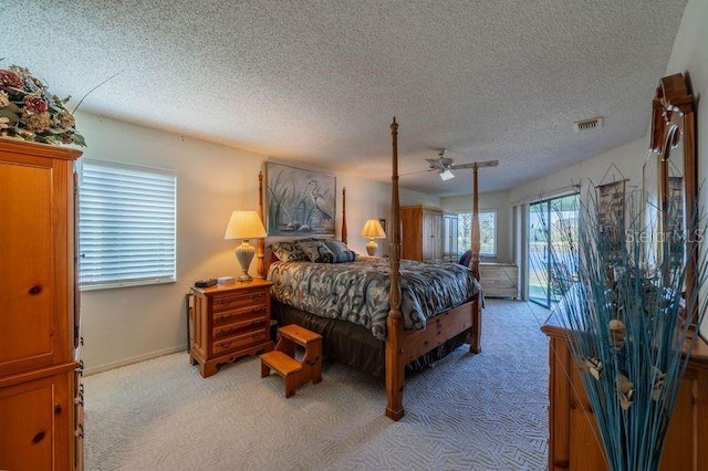 bedroom with ceiling fan, access to outside, light colored carpet, and a textured ceiling