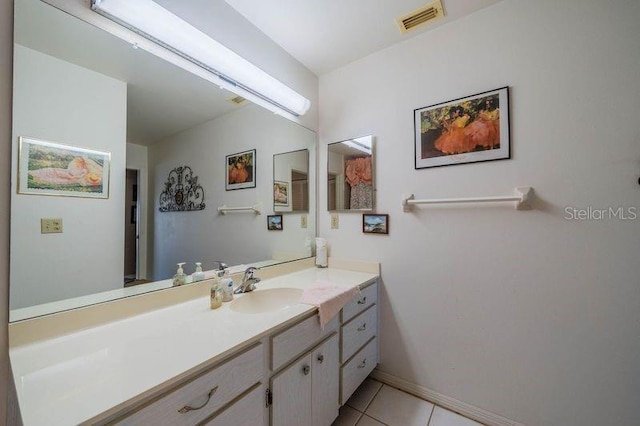 bathroom featuring tile patterned flooring and vanity