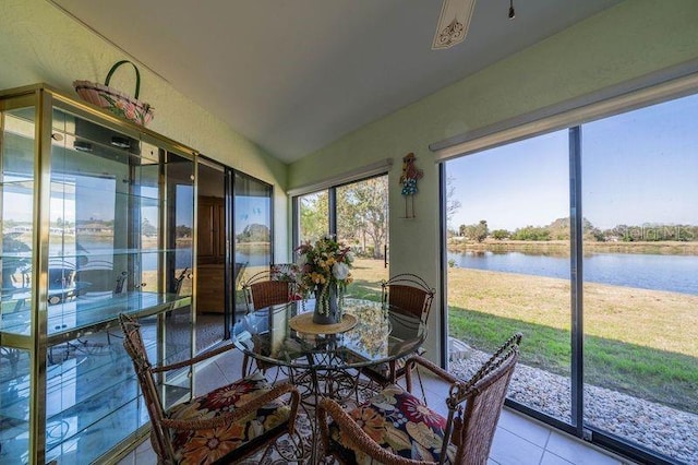 sunroom / solarium featuring a water view, ceiling fan, and vaulted ceiling