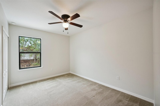 unfurnished room with ceiling fan and light colored carpet