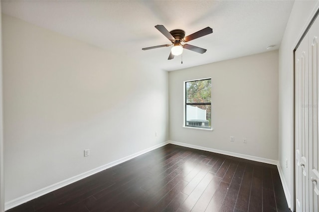 unfurnished bedroom with ceiling fan, dark hardwood / wood-style flooring, and a closet