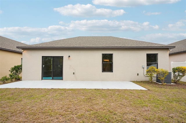 rear view of property featuring central AC, a patio area, and a yard