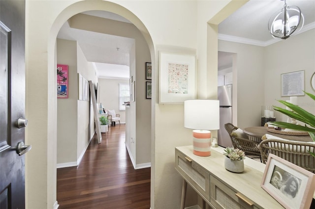 corridor with ornamental molding and dark hardwood / wood-style flooring