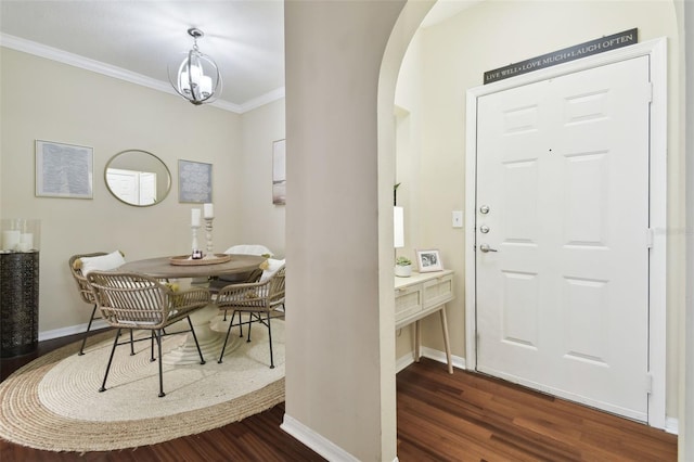 entrance foyer with ornamental molding and dark hardwood / wood-style flooring