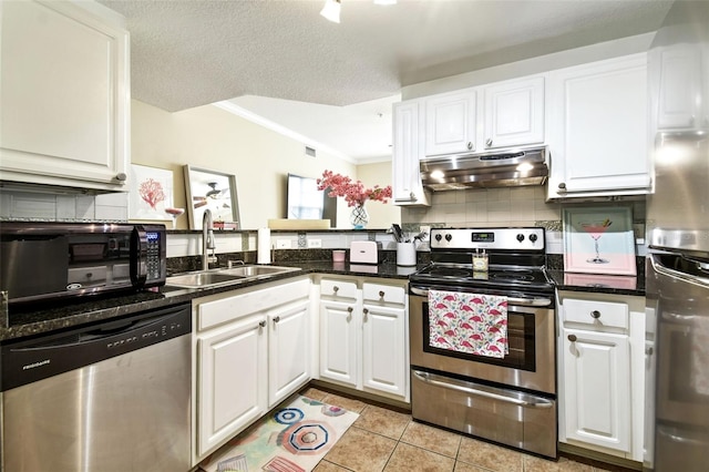 kitchen featuring a textured ceiling, white cabinetry, sink, stainless steel appliances, and light tile patterned flooring