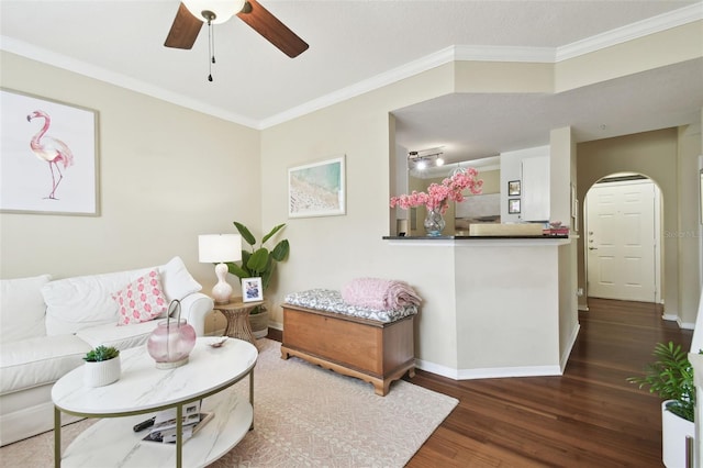 living room with ceiling fan, crown molding, and dark wood-type flooring