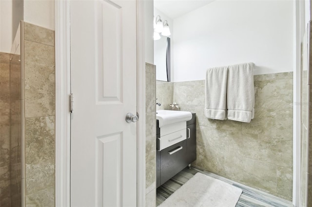 bathroom featuring tile walls and vanity