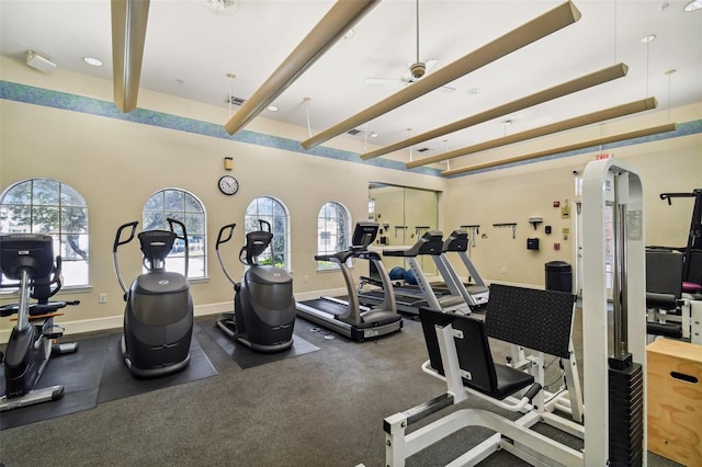 gym featuring ceiling fan, a wealth of natural light, and carpet flooring